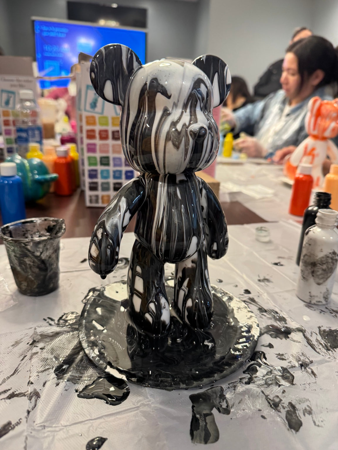 Finished black and white Drip Bear created during a Boom Bear paint party experience