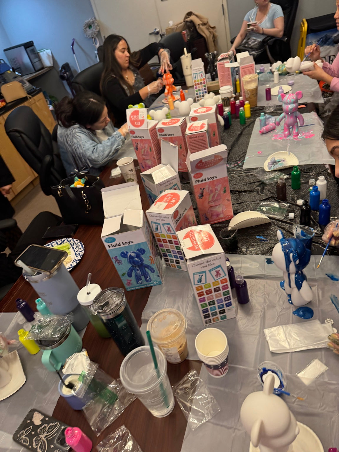 Boom Bear mobile paint party table filled with paints, supplies, and colorful Drip Bears
