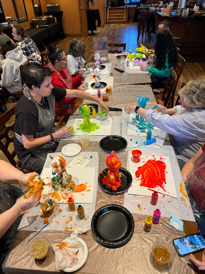 Guests creating colorful Drip Bears together during a Boom Bear mobile paint party experience