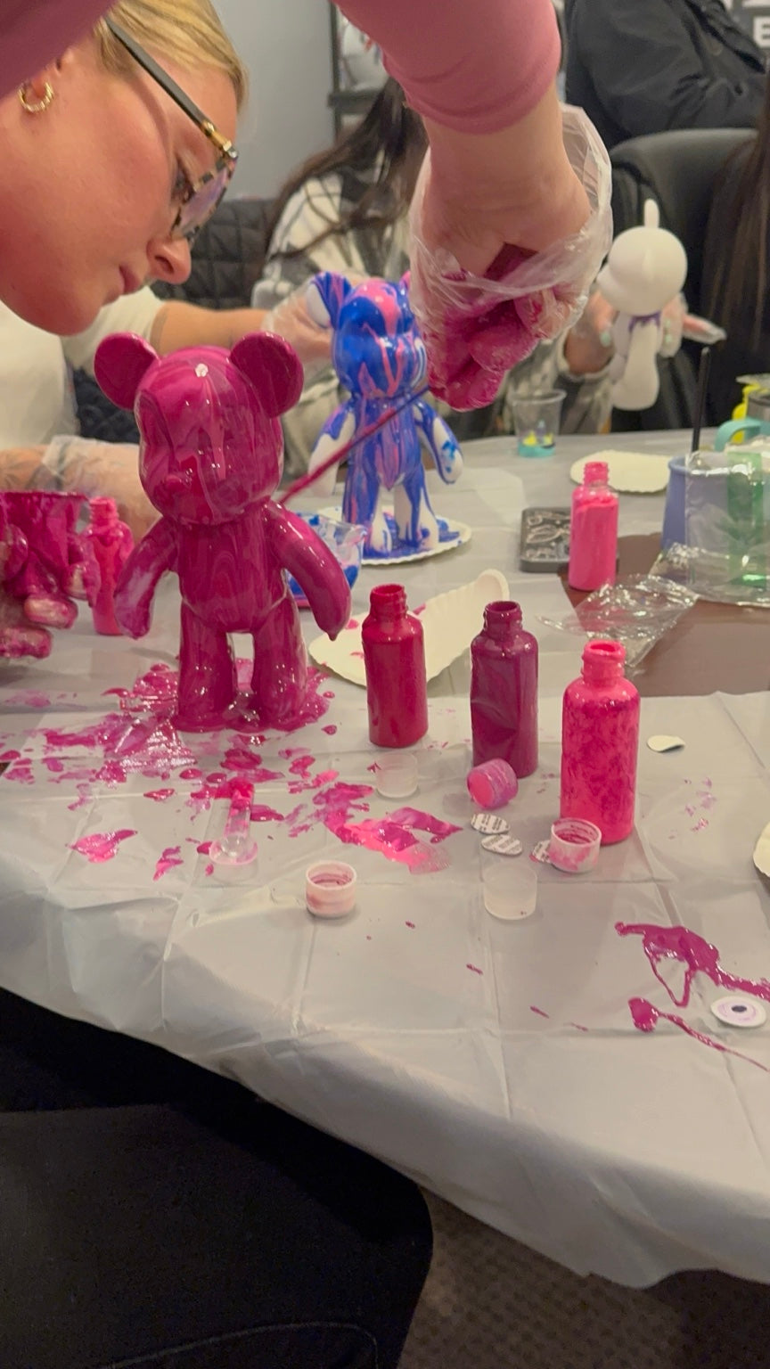 Guest creating a pink Drip Bear during a Boom Bear creative paint party by Spill Your Creativity