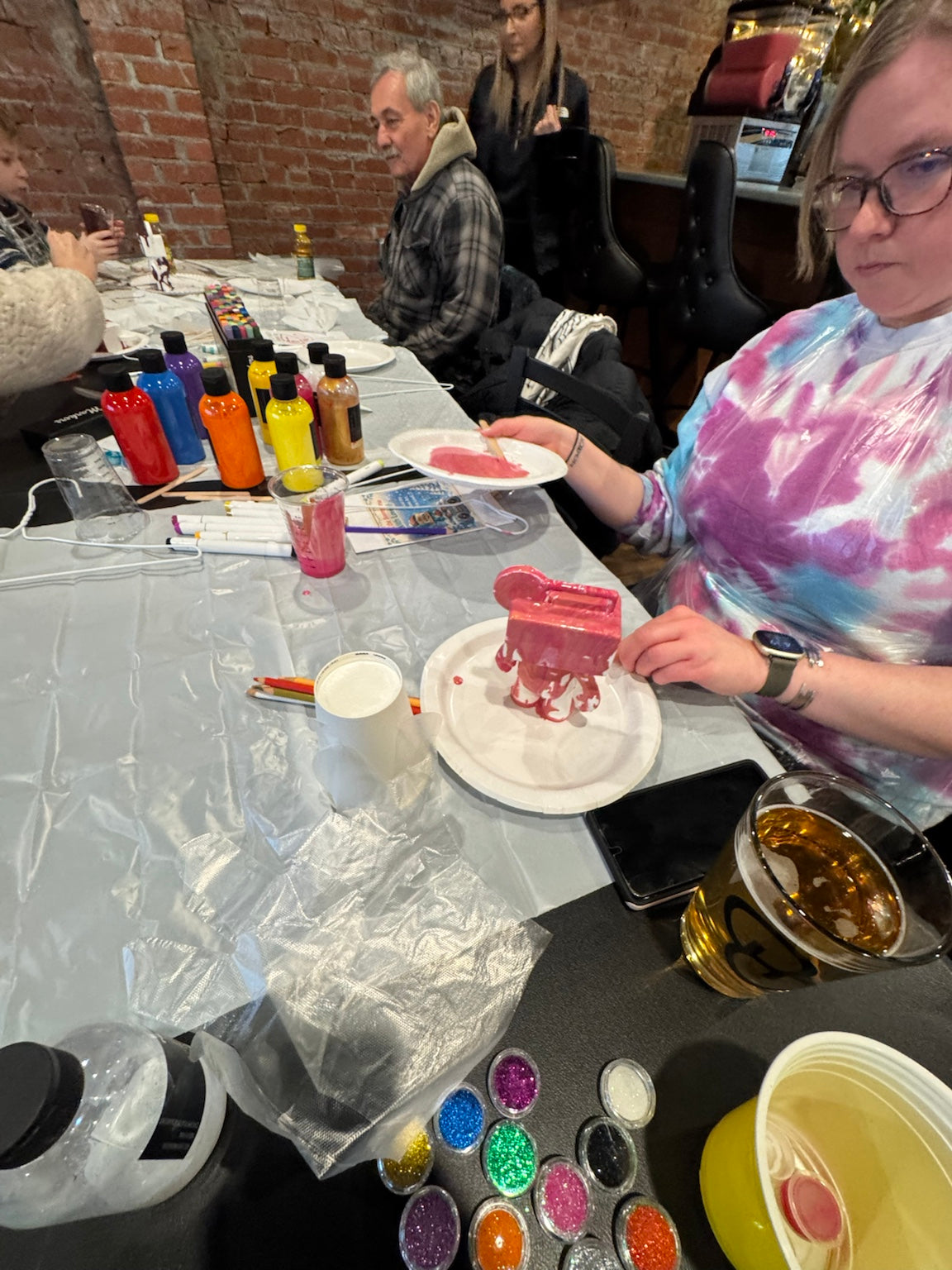 Guest painting a custom Drip Bear during a Boom Bear mobile creative party